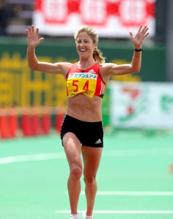 Photo of Kate Smyth running across the line as she finishes the Nagano marathon in 2008.