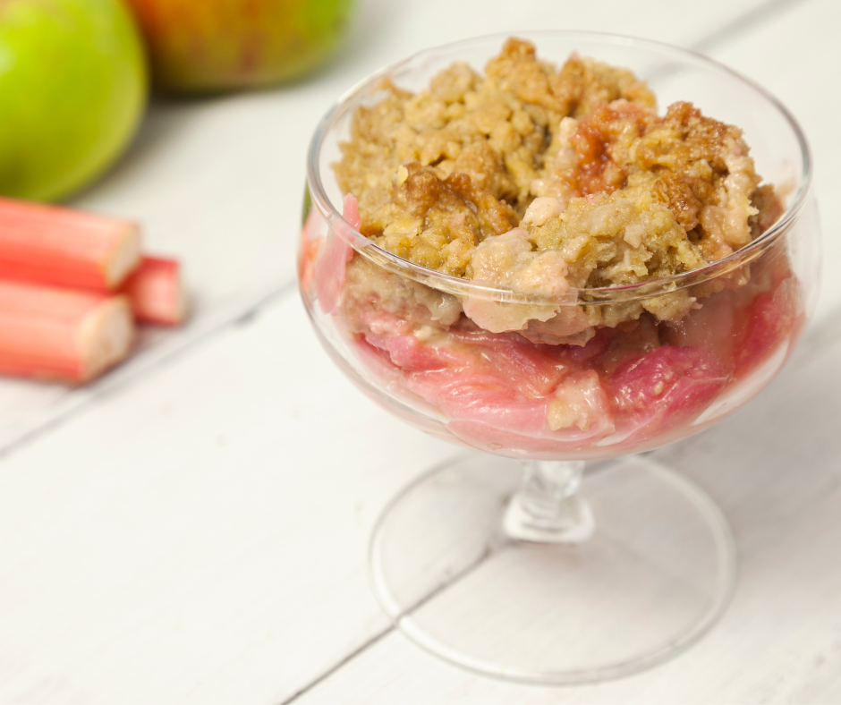Photo of a glass dish of apple and rhubarb crumble.