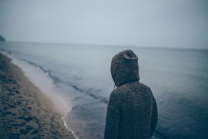 Photo of a female athlete wearing a hoody on a dark gloomy day