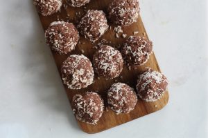 chocolate protein balls on a wooden board