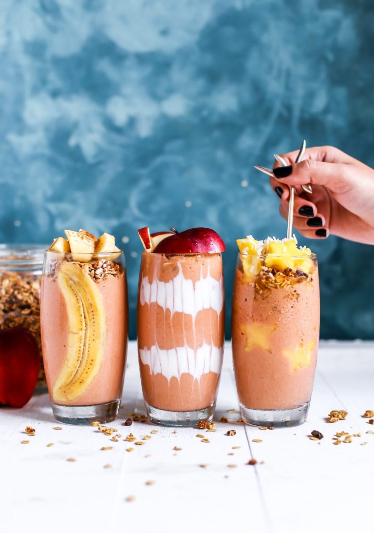 three different breakfast jars are displayed with different fruits