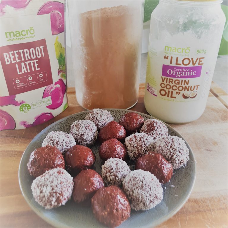 plate of bliss balls with ingredients in background