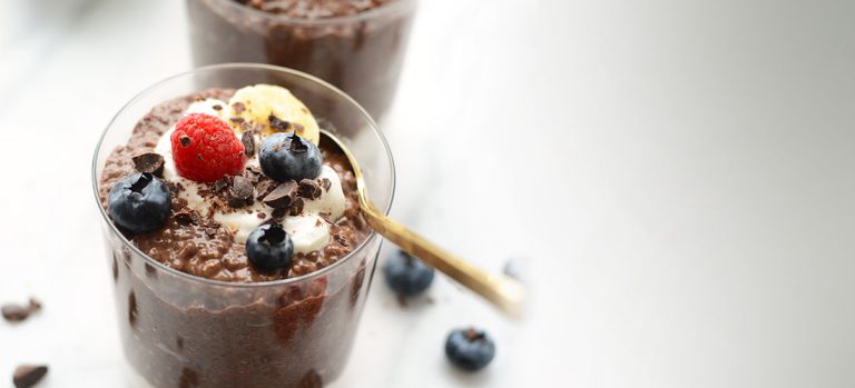 mousse in a bowl with spoon and berries